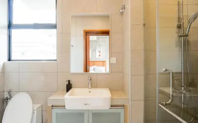 a bathroom with a sink and a mirror and a shower at 68 Palms 04 l Midvalley l 6 Pax in Kuala Lumpur