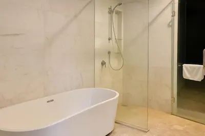 a white bath tub in a bathroom with a shower at Eastern Suites AT Platinum KLCC in Kuala Lumpur