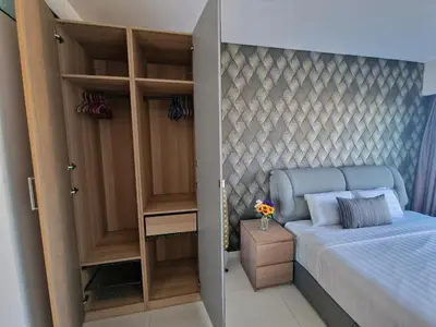 a small bedroom with a bed and a closet at Summer Suites Klcc 2BR Apartments by ATIQ in Kuala Lumpur