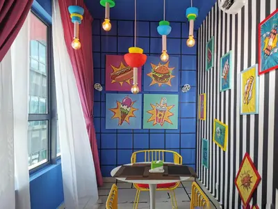 a dining room with a table and a blue wall at Arte Plus Ampang Studio near KLCC - Living Signature in Kuala Lumpur