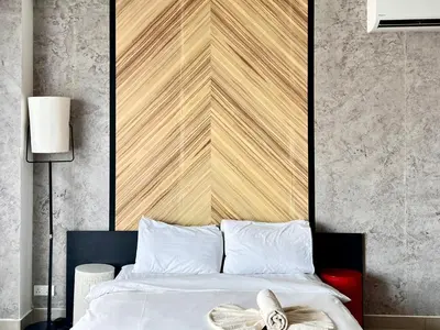 a bedroom with a bed with a large wooden headboard at Arte Plus Ampang Studio near KLCC - Living Signature in Kuala Lumpur
