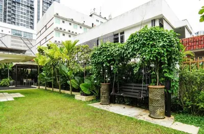 a park with a bench and trees and buildings at 68 Palms 03 l Midvalley l KL Sentral in Kuala Lumpur