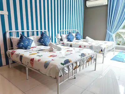 two beds in a room with blue and white stripes at A3A l Near KLCC TRX l Santorini l 18 Guests in Kuala Lumpur