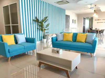 a living room with two blue couches and a coffee table at A3A l Near KLCC TRX l Santorini l 18 Guests in Kuala Lumpur