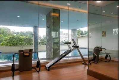 a gym with a treadmill and a swimming pool at A3A l Near KLCC TRX l Santorini l 18 Guests in Kuala Lumpur