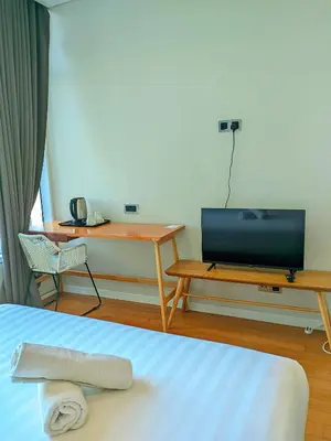 a room with a bed and a desk and a television at Sky Suites KLCC Kuala Lumpur LB in Kuala Lumpur