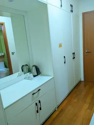 a bathroom with white cabinets and a mirror at Sky Suites KLCC Kuala Lumpur LB in Kuala Lumpur
