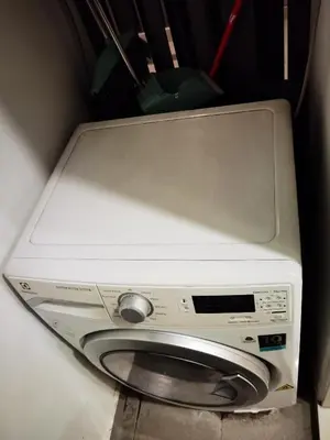 a microwave oven sitting on top of a washing machine at The Roberstson family suite with city views in Kuala Lumpur