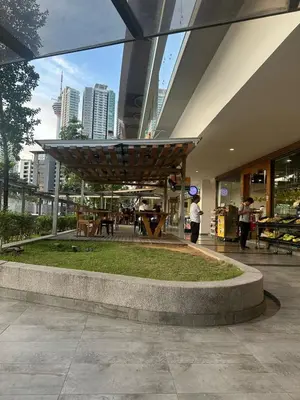 a lobby of a building with a table and benches at The Roberstson family suite with city views in Kuala Lumpur