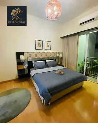 a bedroom with a bed and a chandelier at Ceylon Stay in Kuala Lumpur