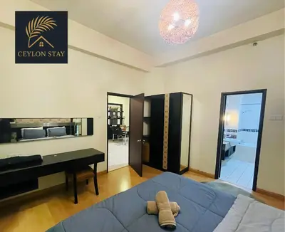 a living room with a blue bed and a piano at Ceylon Stay in Kuala Lumpur