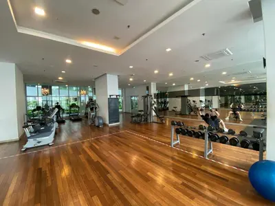 a gym with a hard wood floor and people exercising at Infinity Sky pool hostel best in Kuala Lumpur