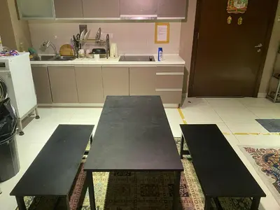 two benches in a kitchen with a table at CloudNest Infinity Sky pool Hostel in Kuala Lumpur