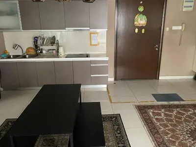 a kitchen with a black table and a brown door at Skyfloat Infinity Hostel in Kuala Lumpur