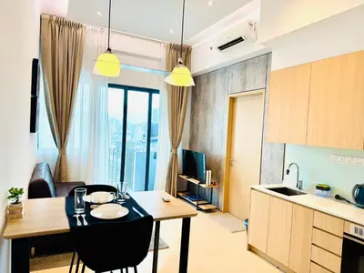 a kitchen and living room with a table and chairs at The Luxe & Colony KLCC By Comfort Dwellings in Kuala Lumpur
