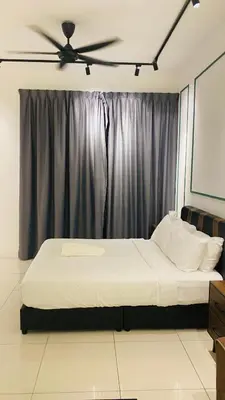 a bedroom with a bed with a ceiling fan at chamber suites by bintang in Kuala Lumpur