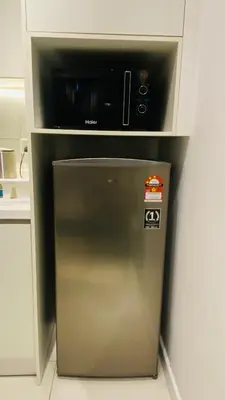 a small refrigerator with a microwave on top of it at chamber suites by bintang in Kuala Lumpur