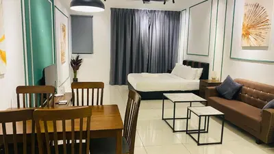a living room with a couch and a table at chamber suites by bintang in Kuala Lumpur