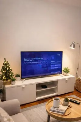 a living room with a flat screen tv on a entertainment center at The Mews Suites KLCC By Luna in Kuala Lumpur