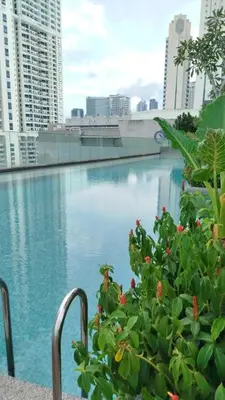 a view of a pool from the balcony of a building at Quill Residence KL Suites in Kuala Lumpur