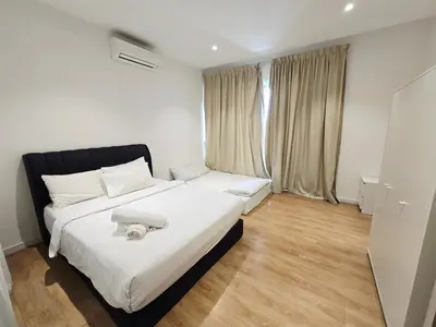 a bedroom with a large bed with white sheets at Quill Residence KL Suites in Kuala Lumpur