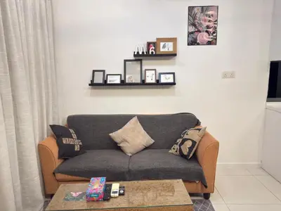 a living room with a couch and a coffee table at Mercu Summer Suites KLCC By Suite Apartment in Kuala Lumpur