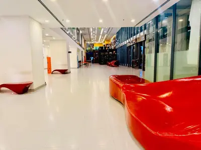 a red leather bench in a shopping mall at Mercu Summer Suites KLCC By Suite Apartment in Kuala Lumpur