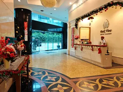 a lobby of a hotel with a man standing at a counter at Parkview Serviced Apartment Kuala Lumpur Twin Tower in Kuala Lumpur