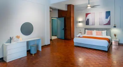 a bedroom with a bed and a desk in it at Embassy Villa by Cobnb at Ampang Hilir in Kuala Lumpur