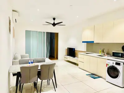 a kitchen and living room with a table and chairs at Majestic Suites KLCC in Kuala Lumpur