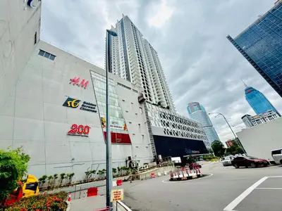 a large building in a city with tall buildings at Majestic Suites KLCC in Kuala Lumpur