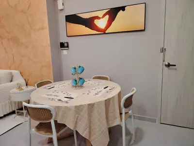 a white table with chairs and a table cloth on it at Agile Residence Dual-Key Gem Bukit Bintang by Natol Chain of Homestays in Kuala Lumpur