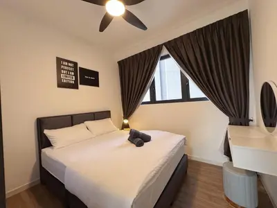 a bedroom with a black teddy bear sitting on a bed at M Vertica Cheras KL City Fully Air-Con Nice View Home in Kuala Lumpur