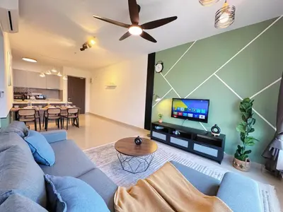 a living room with a blue couch and a tv at M Vertica Cheras KL City Fully Air-Con Nice View Home in Kuala Lumpur
