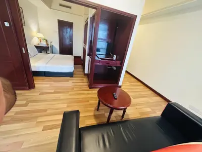 a room with a bed and a couch and a table at PERFECT SUITE at TIMES SQUARE KL in Kuala Lumpur
