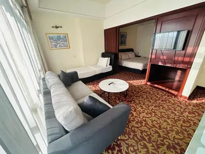a living room with a couch and a mirror at PERFECT SUITE at TIMES SQUARE KL in Kuala Lumpur