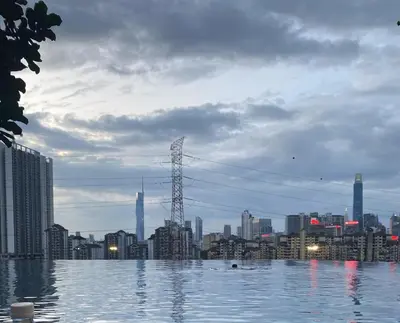 a large pool of water with a city in the background at Cozy Room in Kuala Lumpur