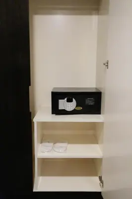 a microwave sitting on a shelf in a room at The Grand Campbell Hotel Kuala Lumpur in Kuala Lumpur