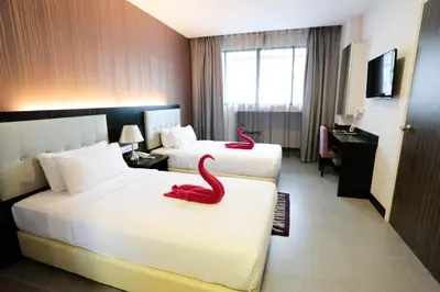 a hotel room with two beds with red snakes on them at The Grand Campbell Hotel Kuala Lumpur in Kuala Lumpur