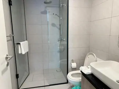 a bathroom with a shower with a toilet and a sink at The Atrium at Jalan Ampang by OKBnB - Classy Executive Family Suite 3Bedroom with Balcony , nearby KLCC in Kuala Lumpur