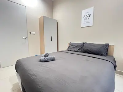 a bedroom with a bed with a stuffed animal on it at Trion KL By Luxe Home in Kuala Lumpur