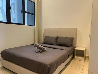 a bed with a pair of shoes sitting on it at Trion KL By Luxe Home in Kuala Lumpur