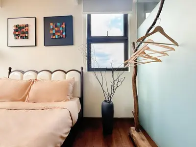 a bedroom with a bed and a vase on the floor at Cozy Studio l Riveria City l 1km to KL Sentral in Kuala Lumpur