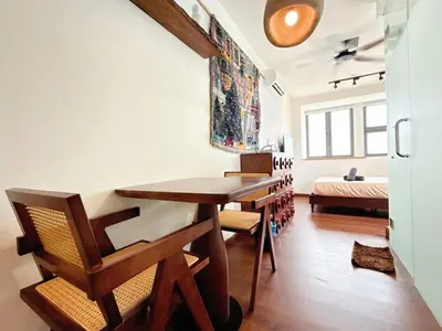 a dining room with a wooden table and chairs at Cozy Studio l Riveria City l 1km to KL Sentral in Kuala Lumpur