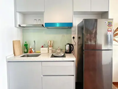 a small kitchen with a stainless steel refrigerator at Cozy Studio l Riveria City l 1km to KL Sentral in Kuala Lumpur