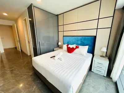 a bedroom with a large white bed with red pillows at PLATINUM SUITE by KUALALUMPUR MALAYSIA in Kuala Lumpur