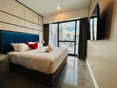 a bedroom with a large bed with a large window at PLATINUM SUITE by KUALALUMPUR MALAYSIA in Kuala Lumpur
