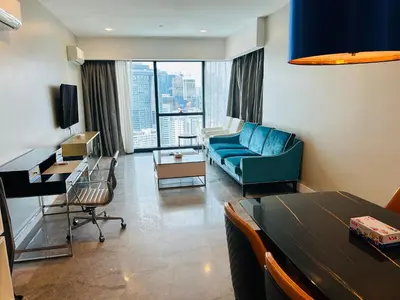 a living room with a blue couch and a table at PLATINUM SUITE by KUALALUMPUR MALAYSIA in Kuala Lumpur