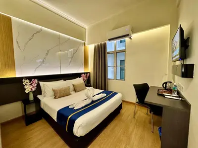 a hotel room with a bed and a desk at Central City Hotel at Chinatown in Kuala Lumpur