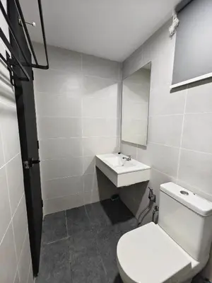 a bathroom with a toilet and a sink and a mirror at Aiman Damia Homestay in Kuala Lumpur